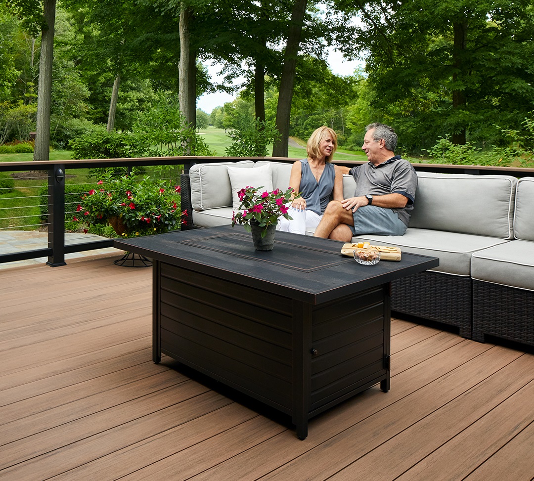 couple sitting on patio furniture on deck