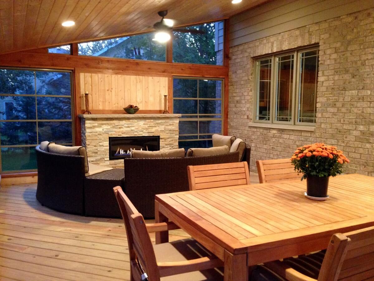 Custom screened porch with dining area and fireplace