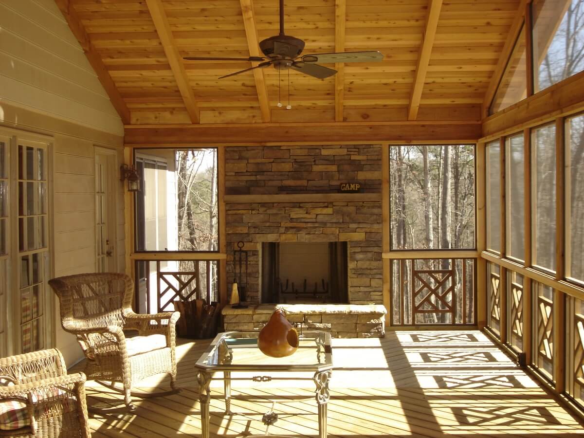 Rustic screened porch with custom outdoor fireplace