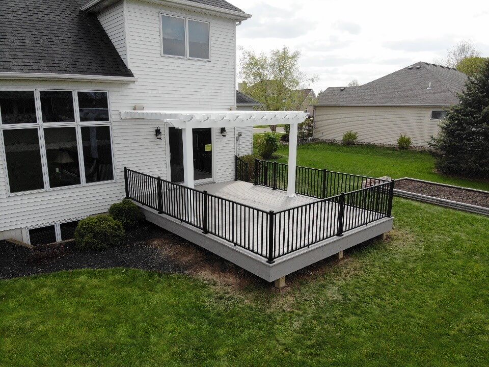 Custom backyard low maintenance deck with railing and pergola