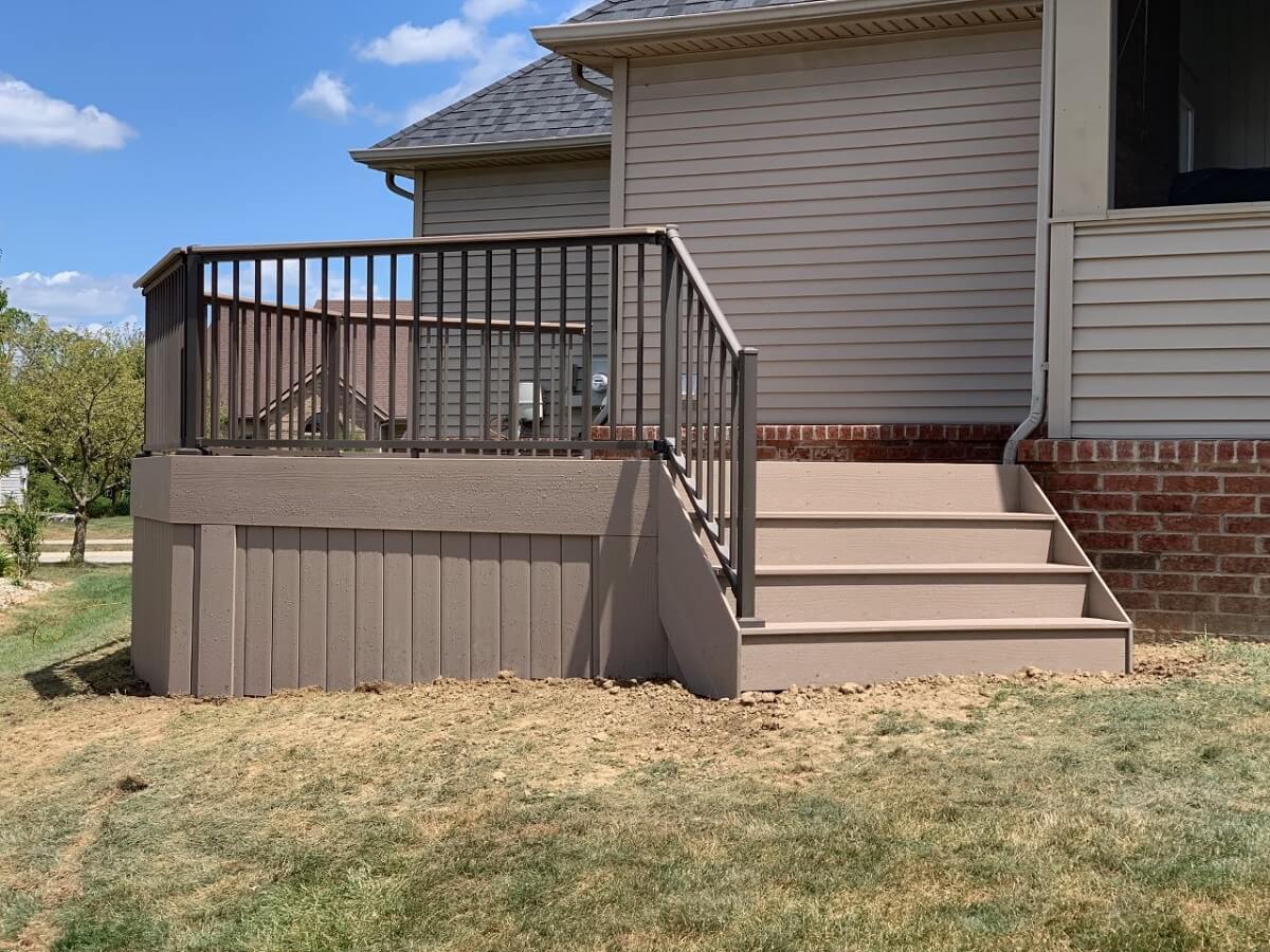 Custom backyard deck with railing and stairs