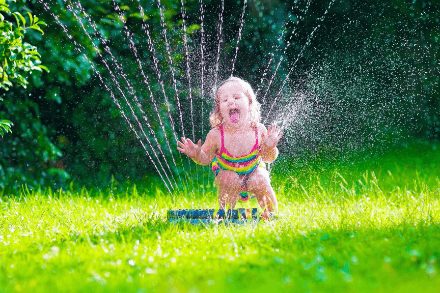 Kid enjoying water sprinklers