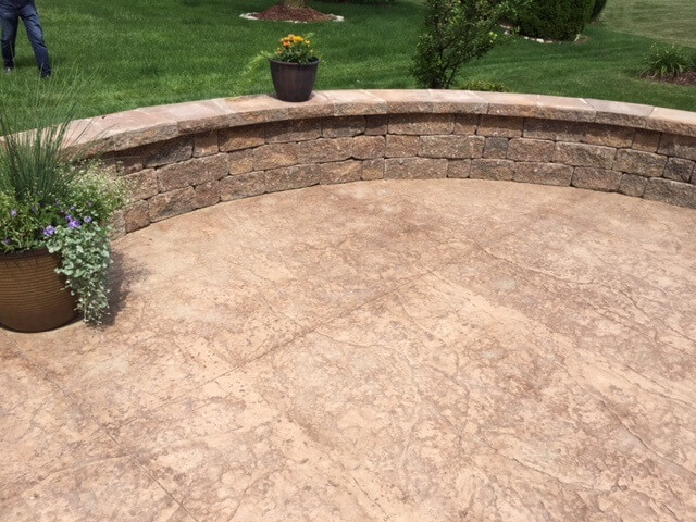 Stained concrete patio with sitting wall