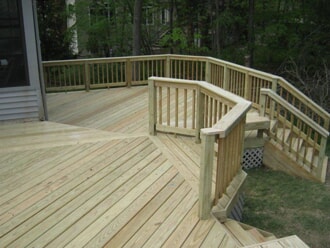 wood multi level deck with railings and stairs