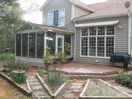 screened porch with small patio and landscaping