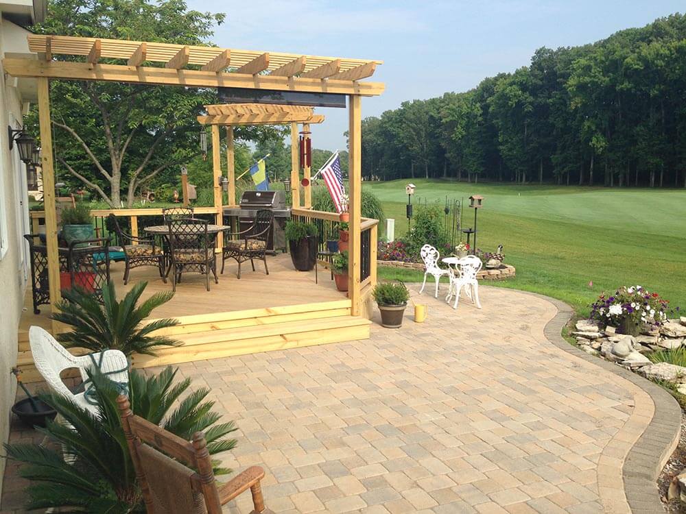 Custom backyard deck and patio with pergola