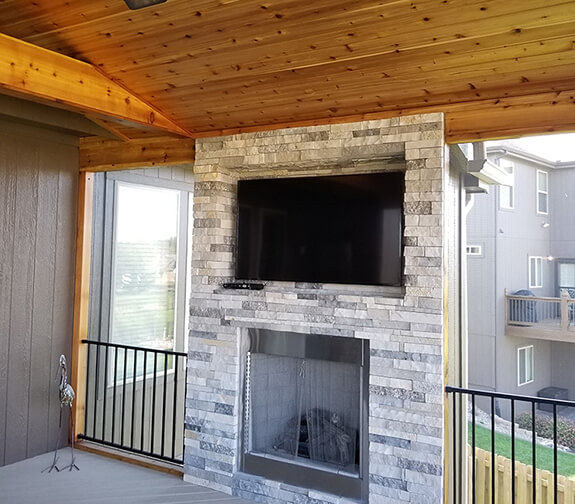 Outdoor fireplace on covered patio