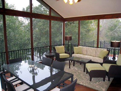 screened porch with couch and chairs