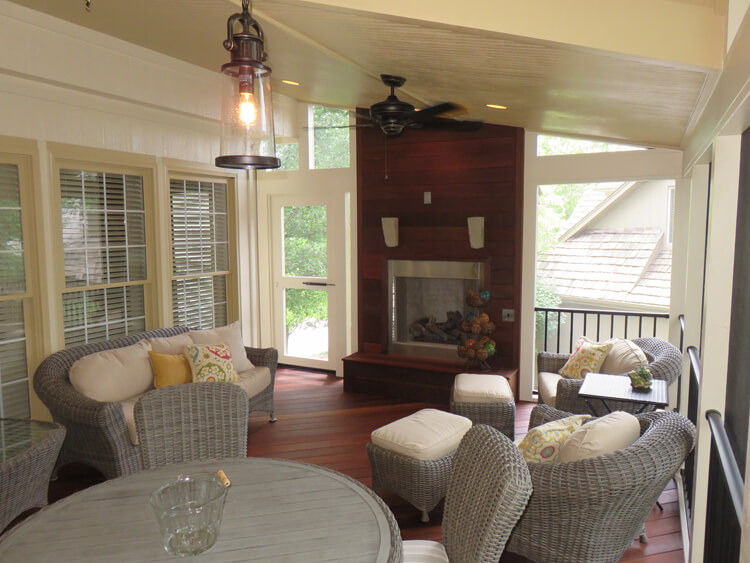 Outdoor fireplace on custom screened porch