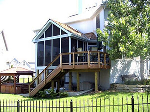 Custom backyard screened porch and deck with staircase