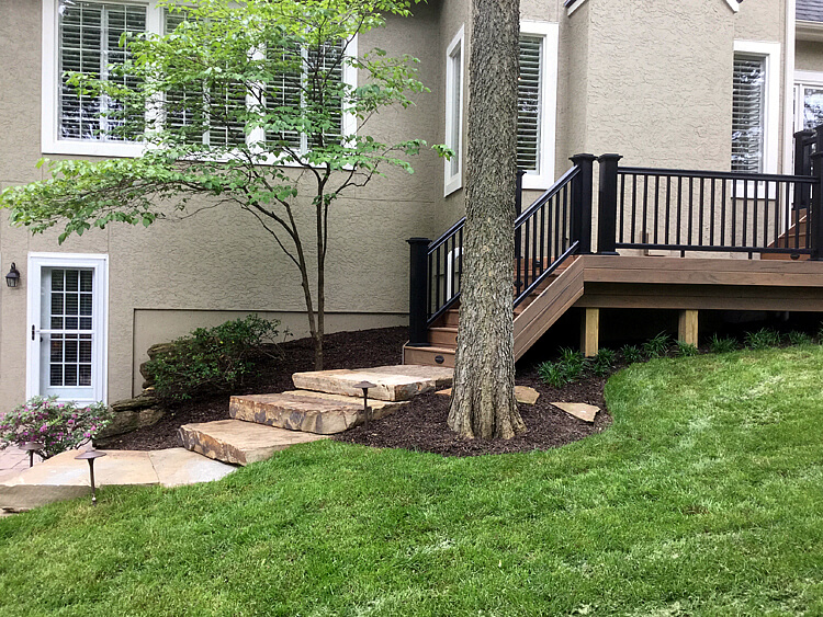 Low maintenance deck and stairs with railing and lighting