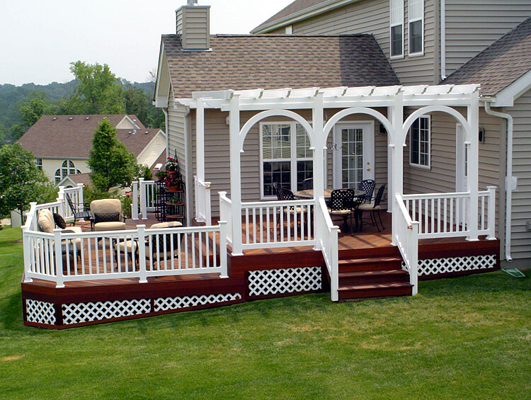 Custom multi-level backyard deck with pergola and railing