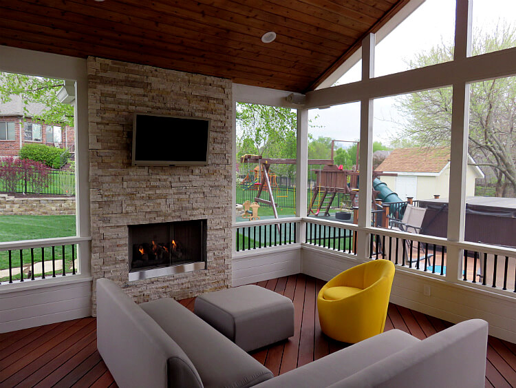 Outdoor fireplace and flat TV on custom screened porch