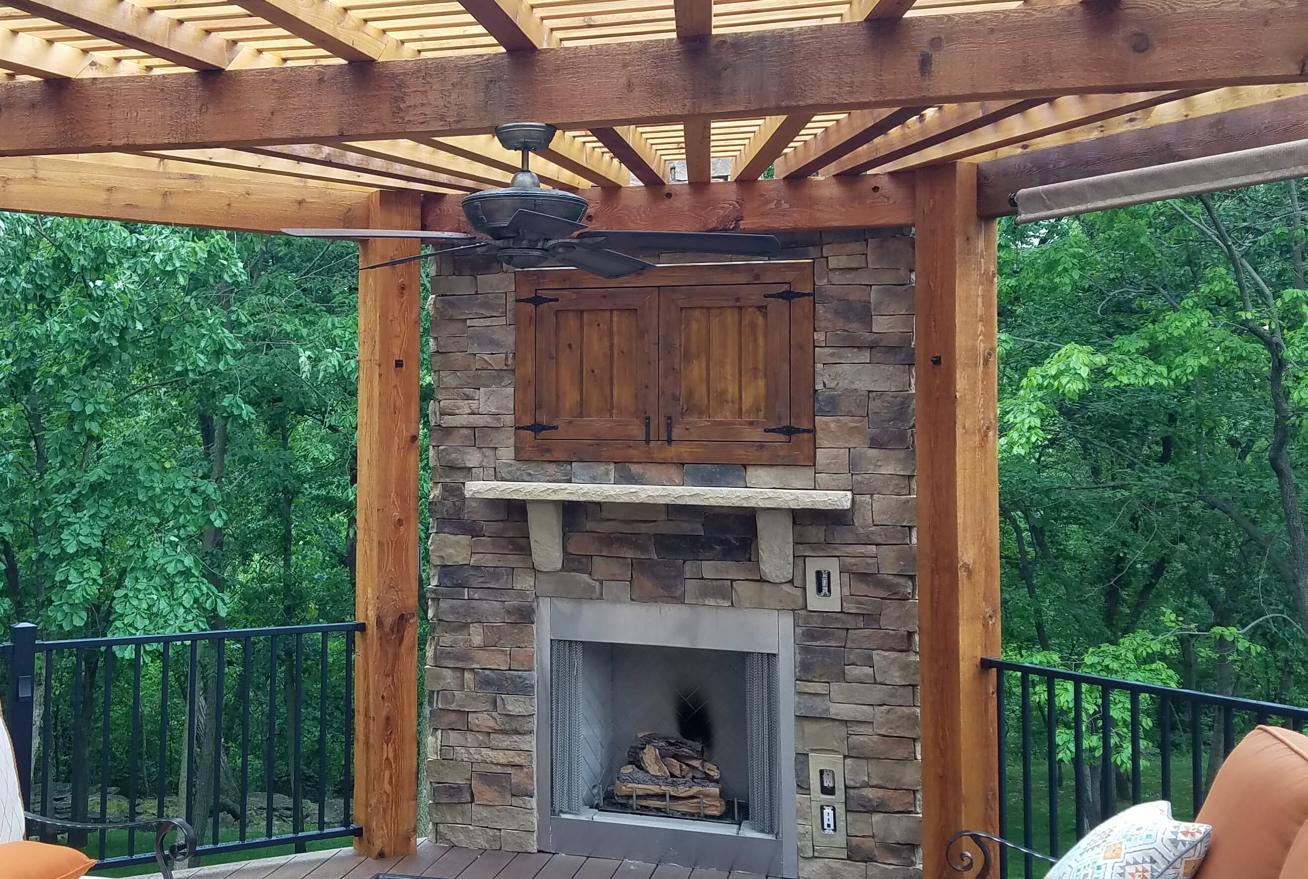 Outdoor fireplace and pergola on deck