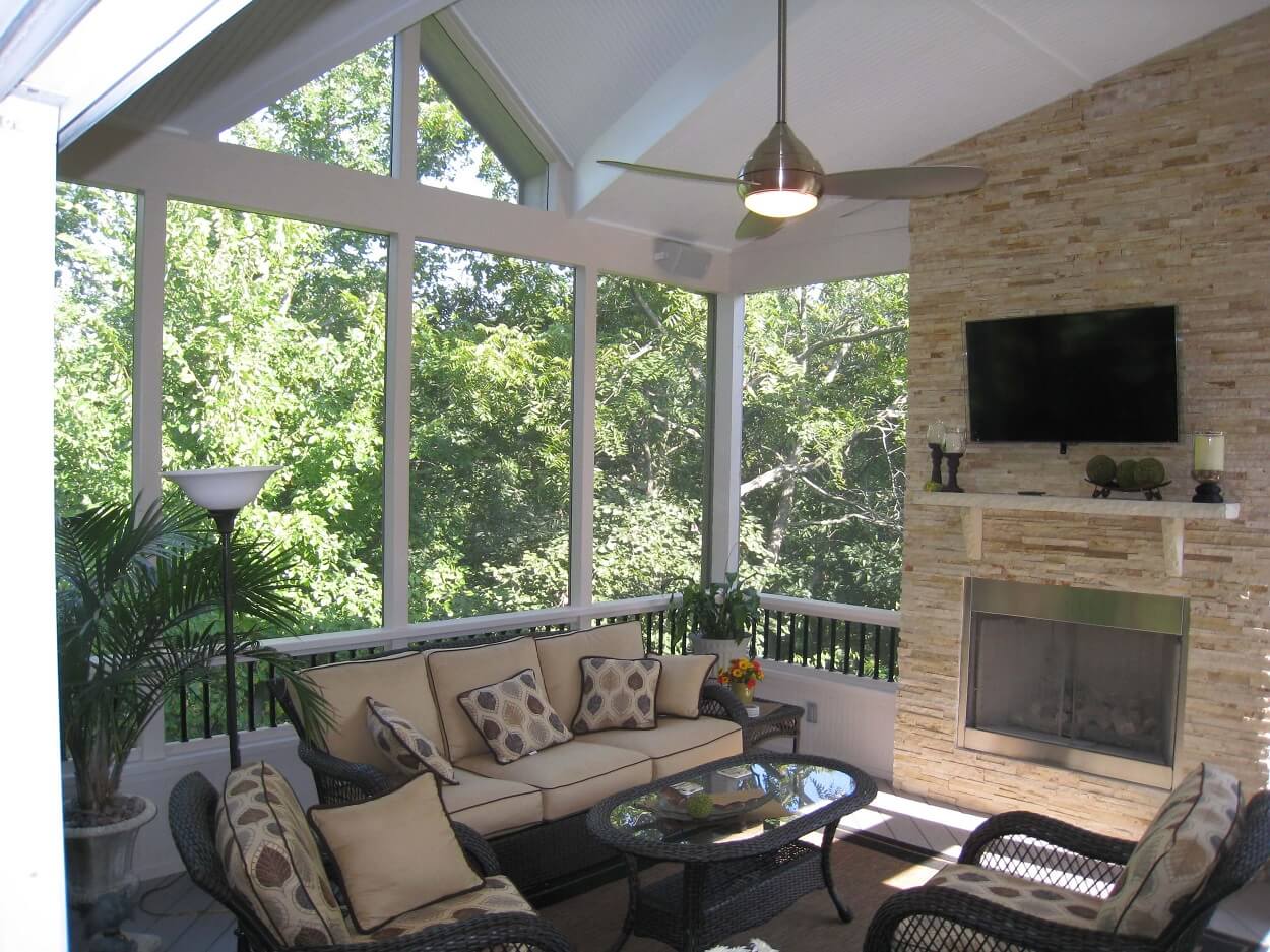 screened porch with inset gable roof and outdoor fireplace