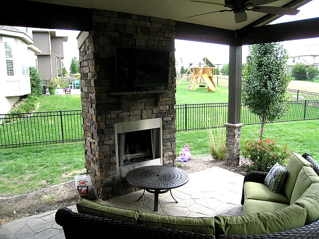 Custom outdoor fireplace on open porch.