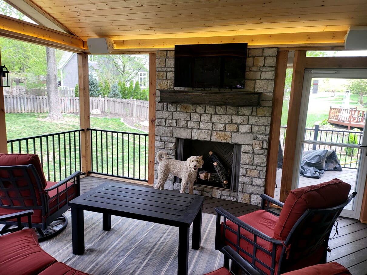 dog in front of fireplace on screened porch