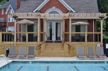 Poolside wooden deck with pergola