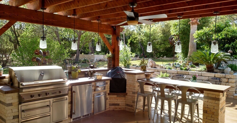 This-patio-features-an-outdoor-kitchen-with-an-overhead-pergola-finished-with-a-Polygal-cover