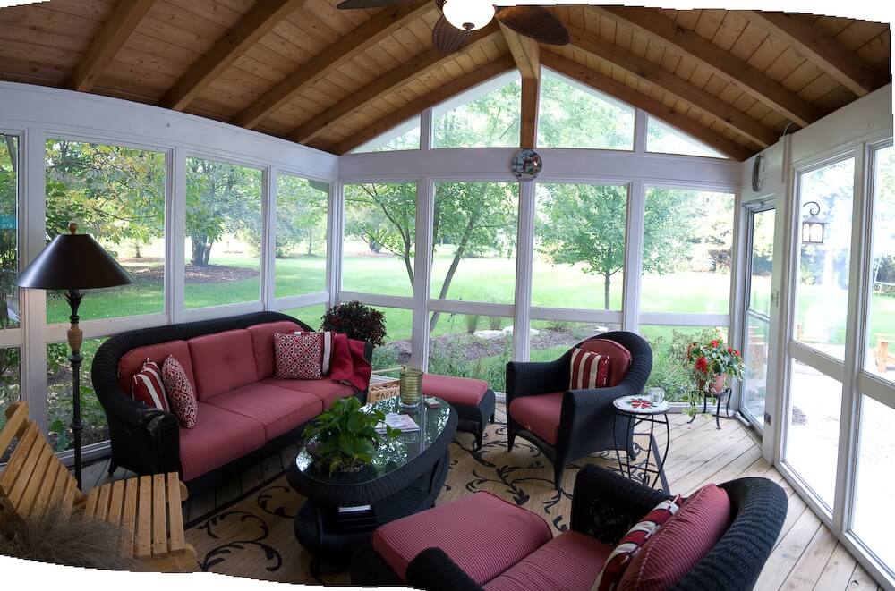 completely covered sun room with floor to ceiling windows and a wood paneled roof