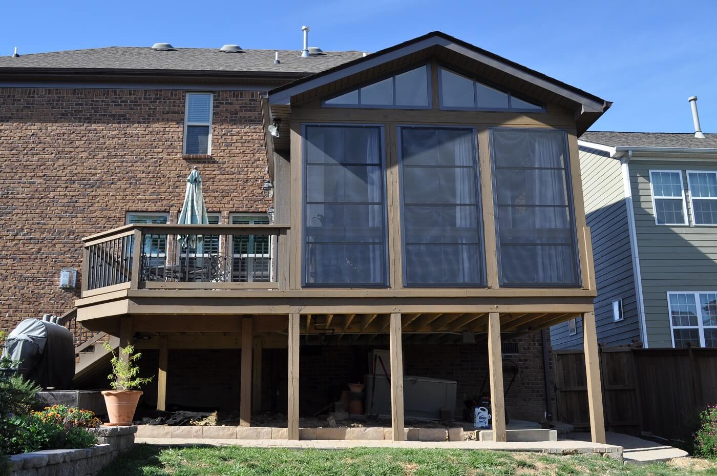 covered porch with large windows