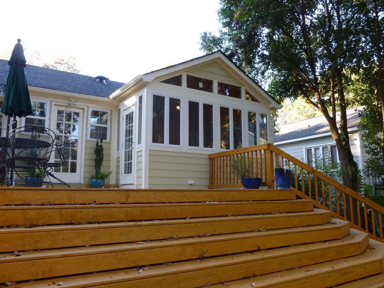 grand wood stairs with sunroom