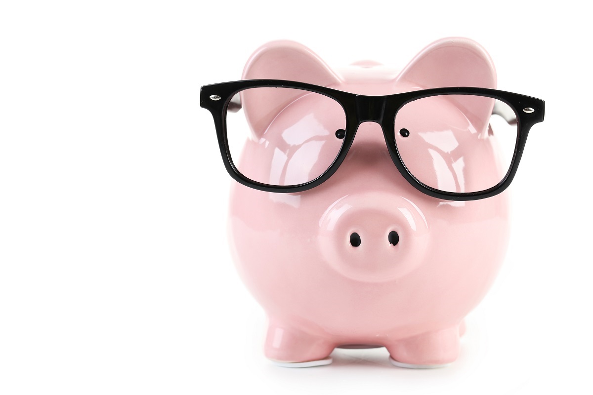 Pink piggy bank with glasses