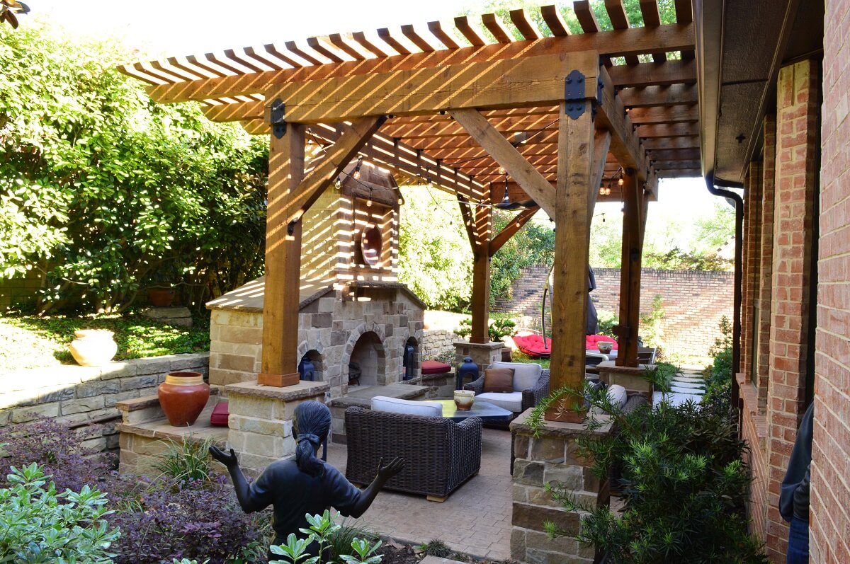 outdoor fireplace with plants and statue