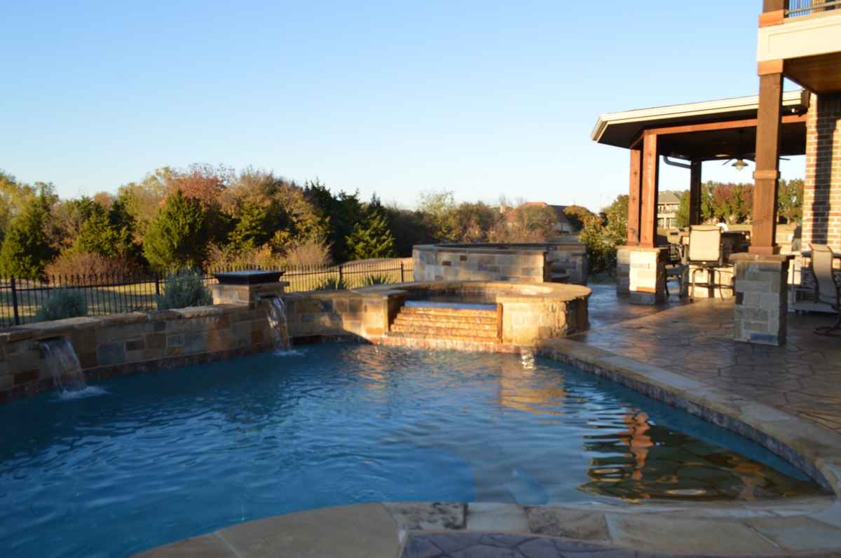Outdoor pool area with waterfall