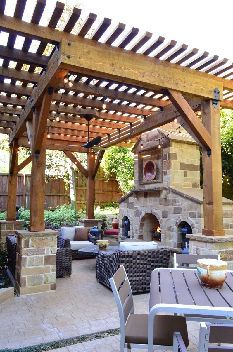 Pergola above seating area and next to outdoor fireplace