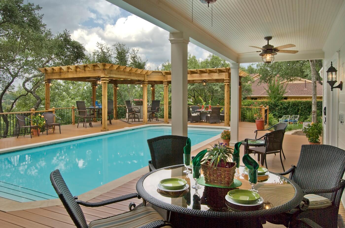 poolside patio with chairs and table
