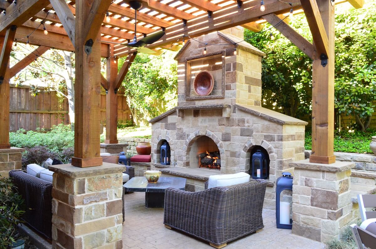 Custom patio with outdoor fireplace and pergola