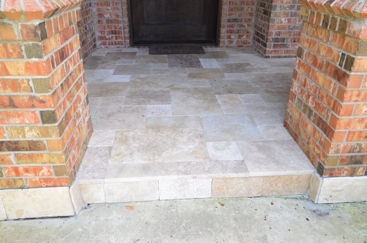 Travertine in a porch entry laid out in a random pattern