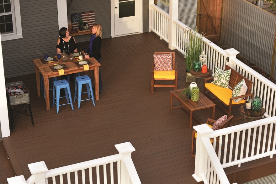 two women enjoying a conversation at the table on their deck