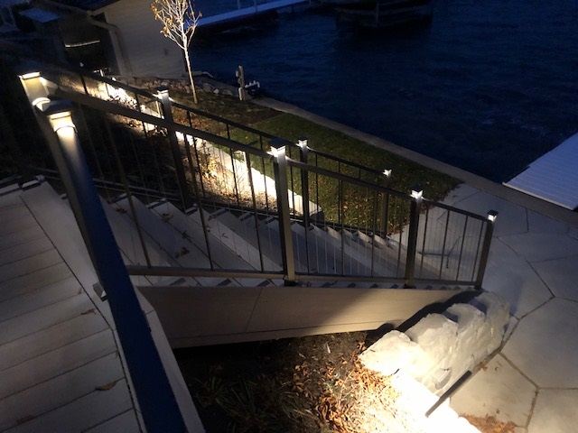 stairs with railing and lights
