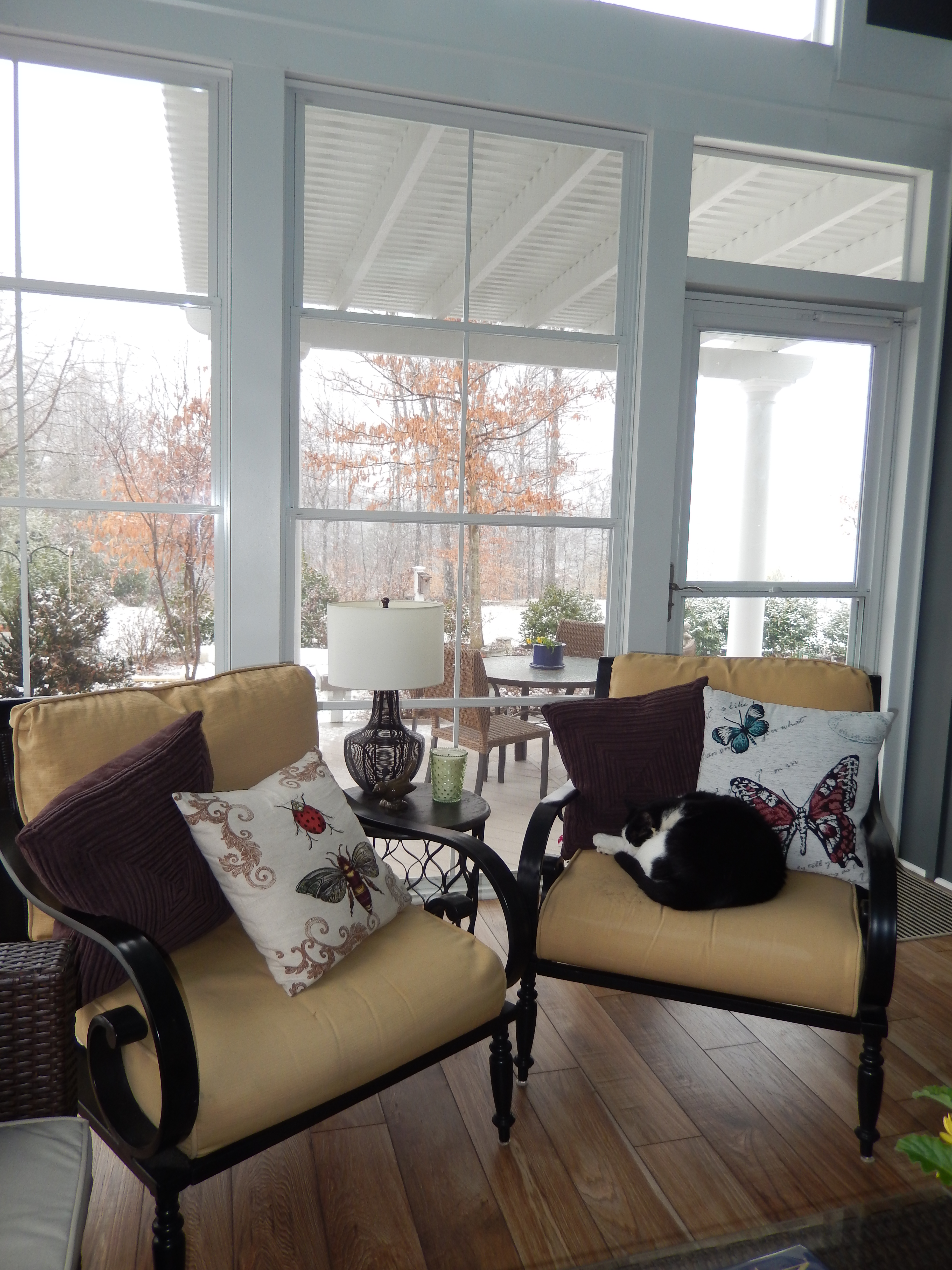 Sunroom with chairs and a side table.