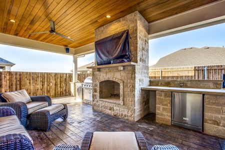 natural stone fireplace under covered patio