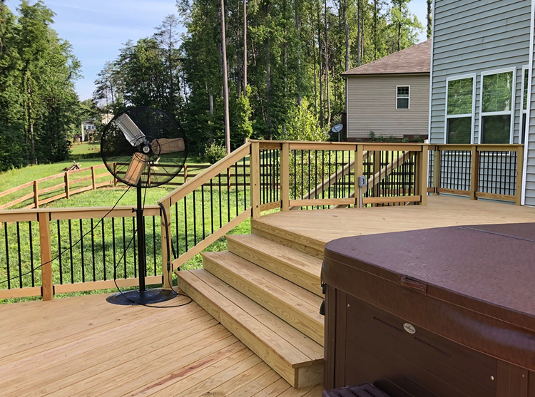 Deck with wood deck rail and black pickets