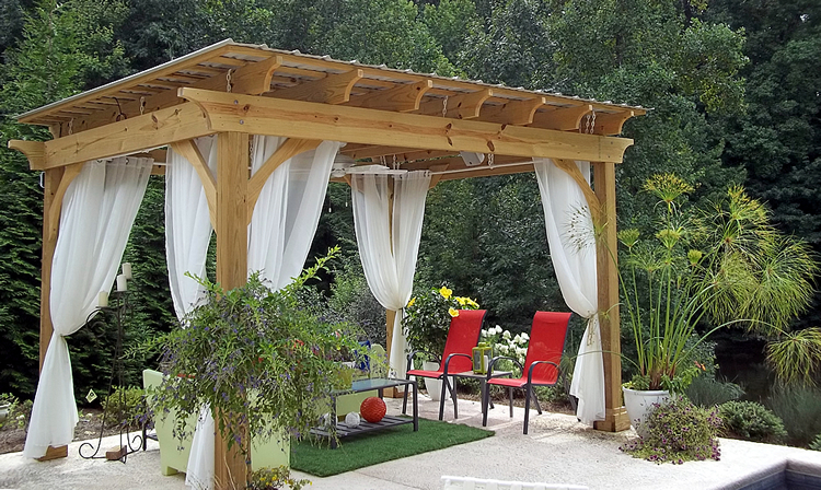 Pergola with curtains and a dining set.
