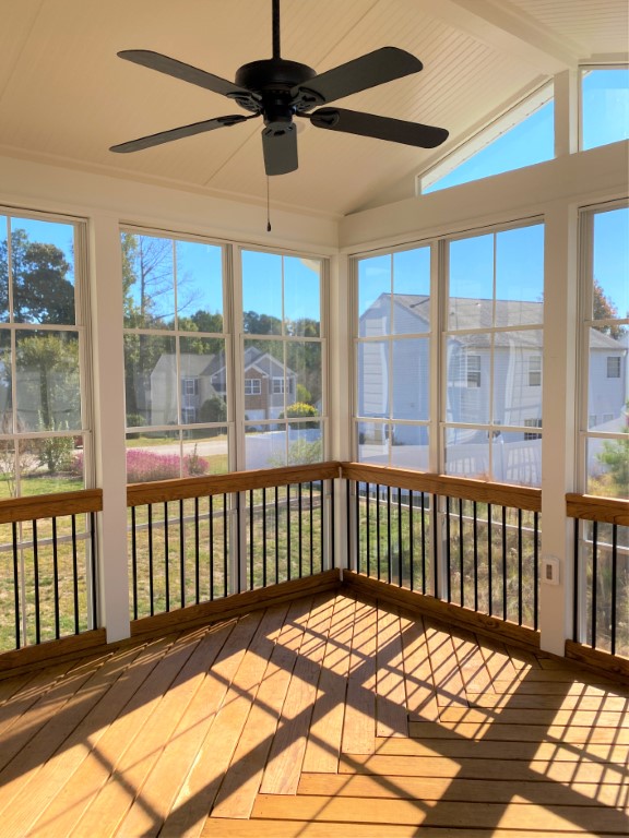 Screened in porch with wooden floors and high ceilings