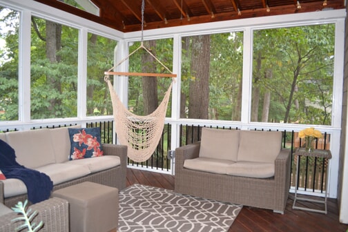 inside sunroom with furniture and hanging swing