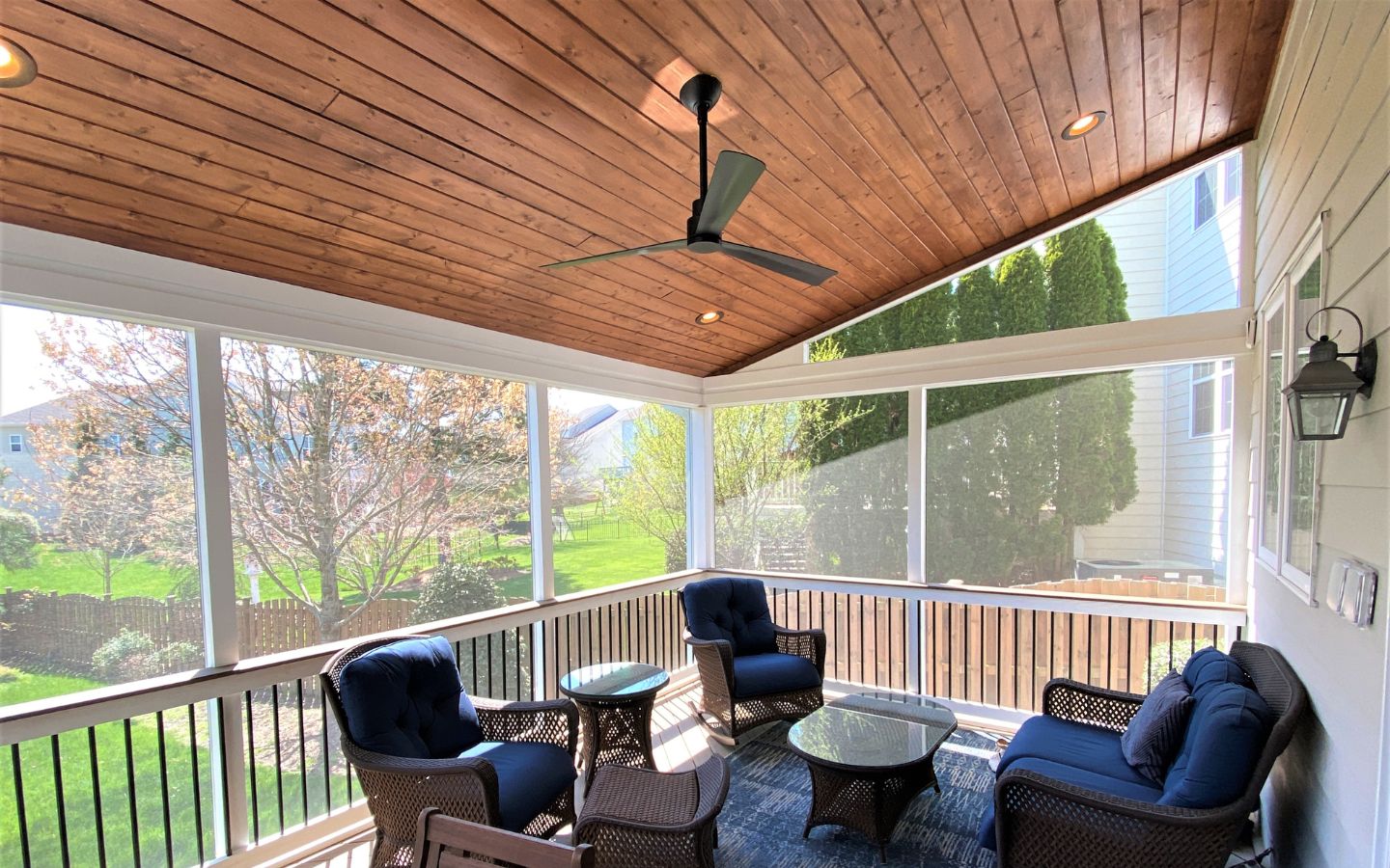 A porch with a ceiling fan and chairs
AI-generated content may be incorrect.