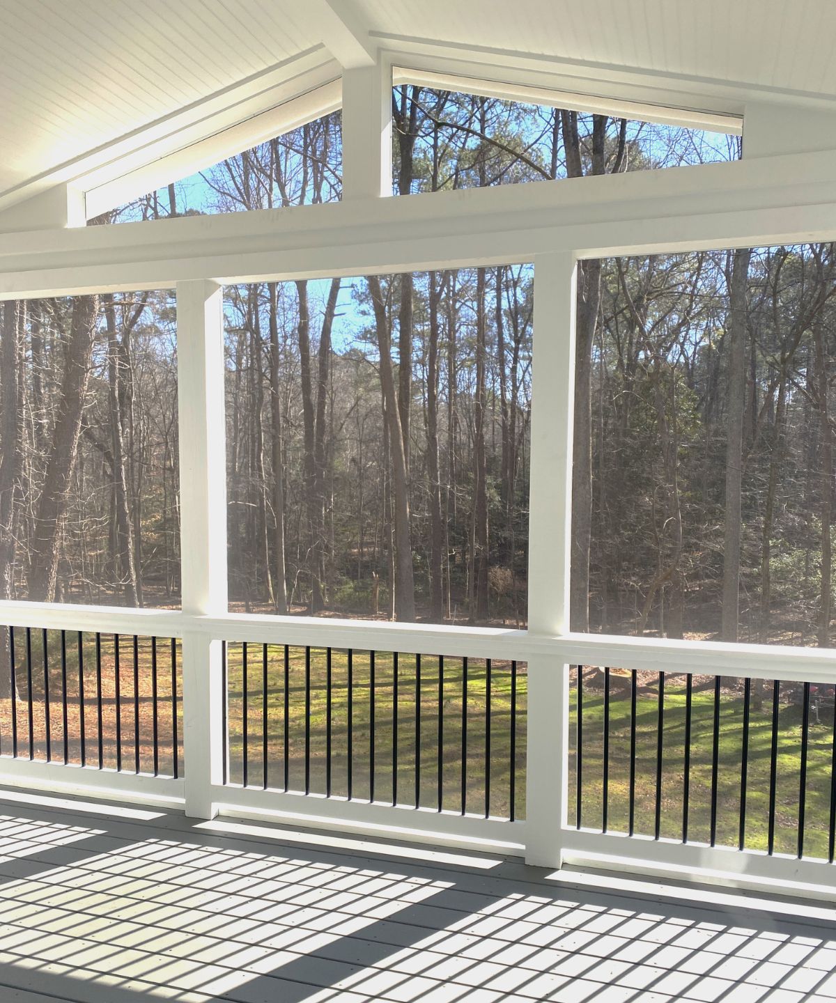 A porch with a view of the forest
AI-generated content may be incorrect.