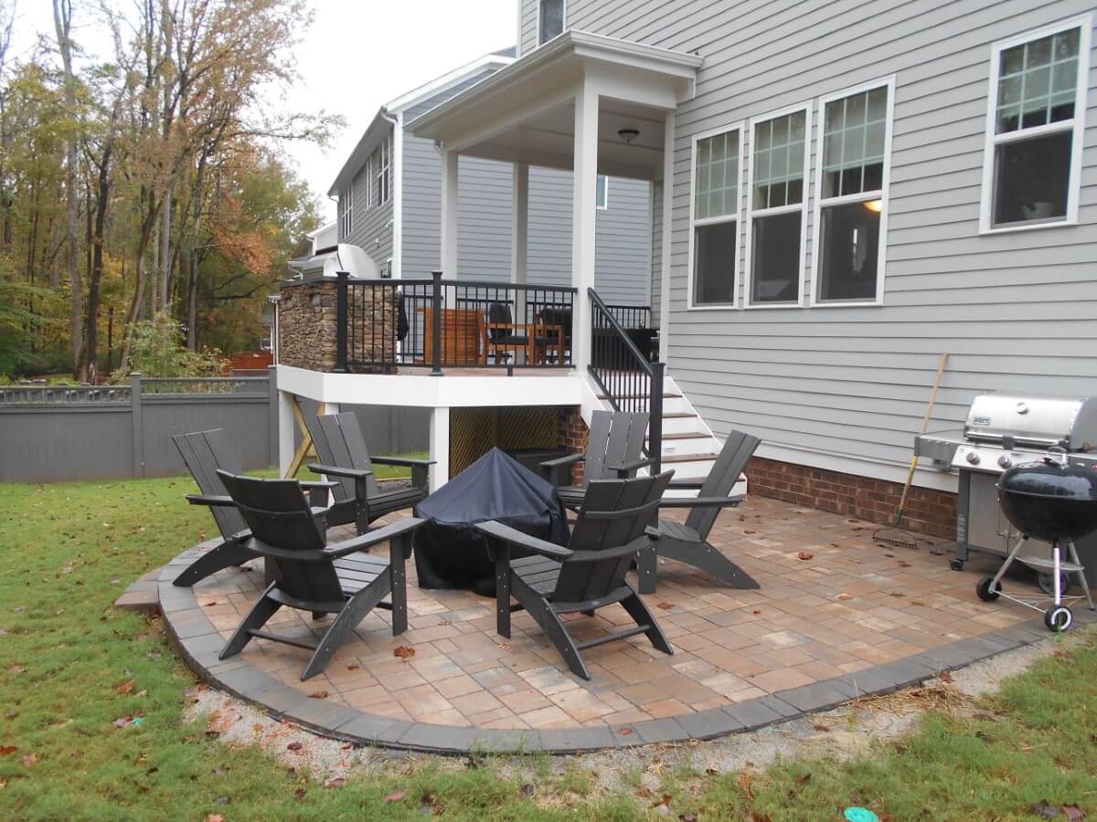 Raleigh backyard with paver patio and fire pit a deck and a covered porch 