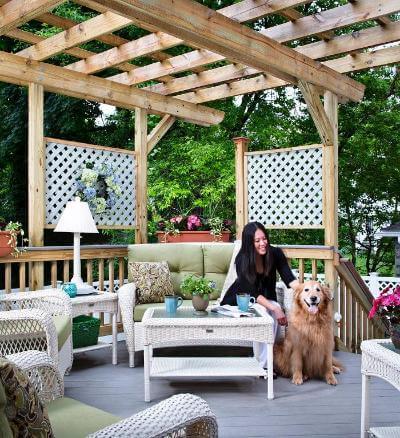 Woman and her dog relaxing under a pergola