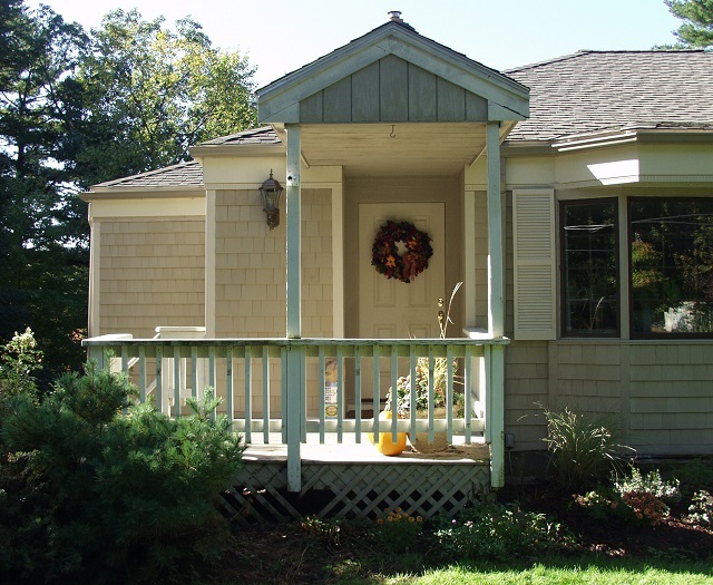 Before image of a home with a small porch.