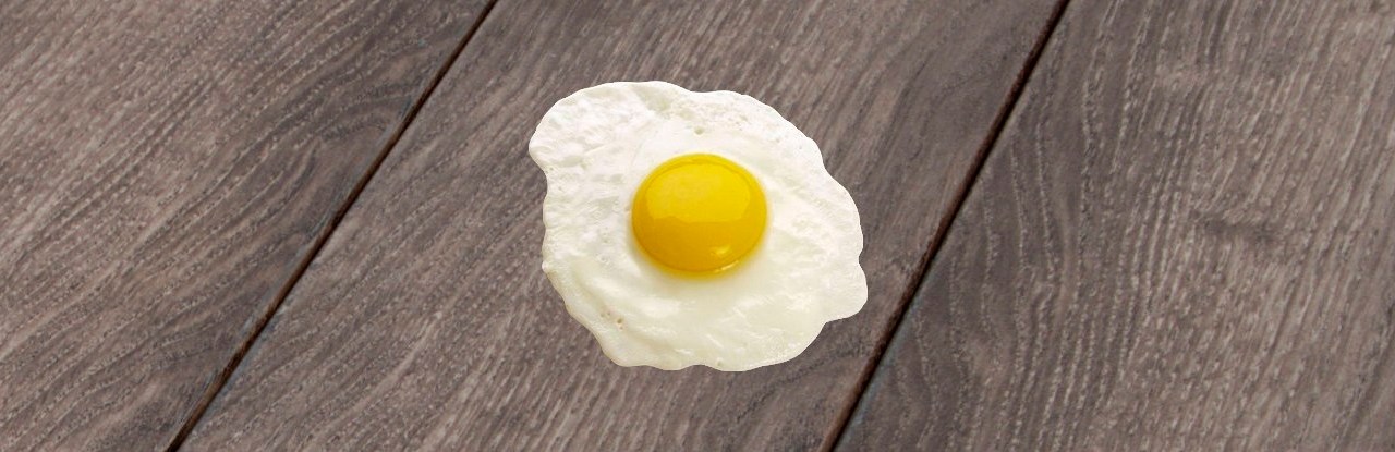 Image of fried egg on wooden deck