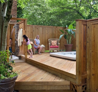 wood deck around hot tub with privacy fence
