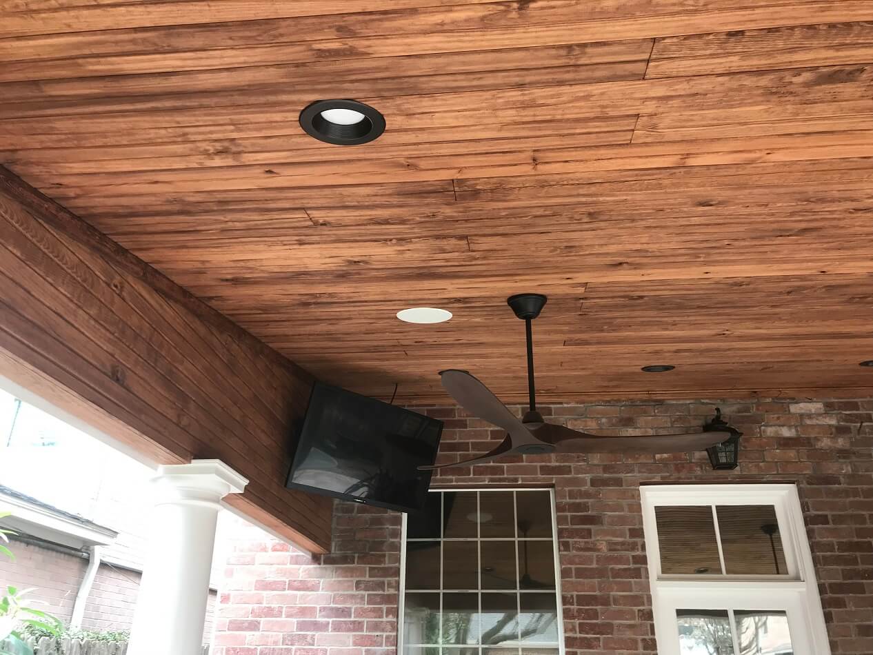 Covered patio with ceiling fan and TV
