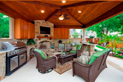 Furnished outdoor shaded pergola with kitchen and fire feature
